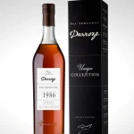 Bouteille d'armagnac de la Collection Unique millésime 1986 Domaine de Cantau avec son étui sur fond blanc.